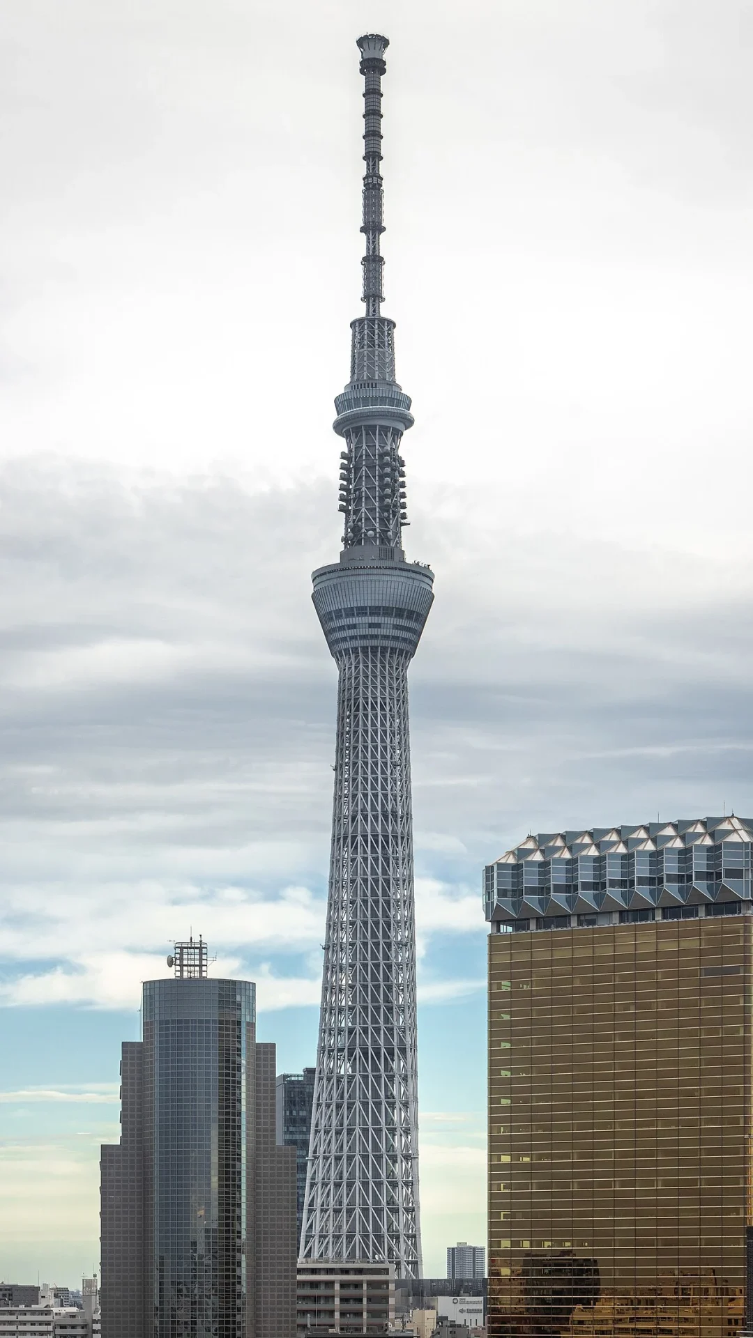 Tokyo Skytree and its two observation decks rising above buildings, viewed from Asakusa
